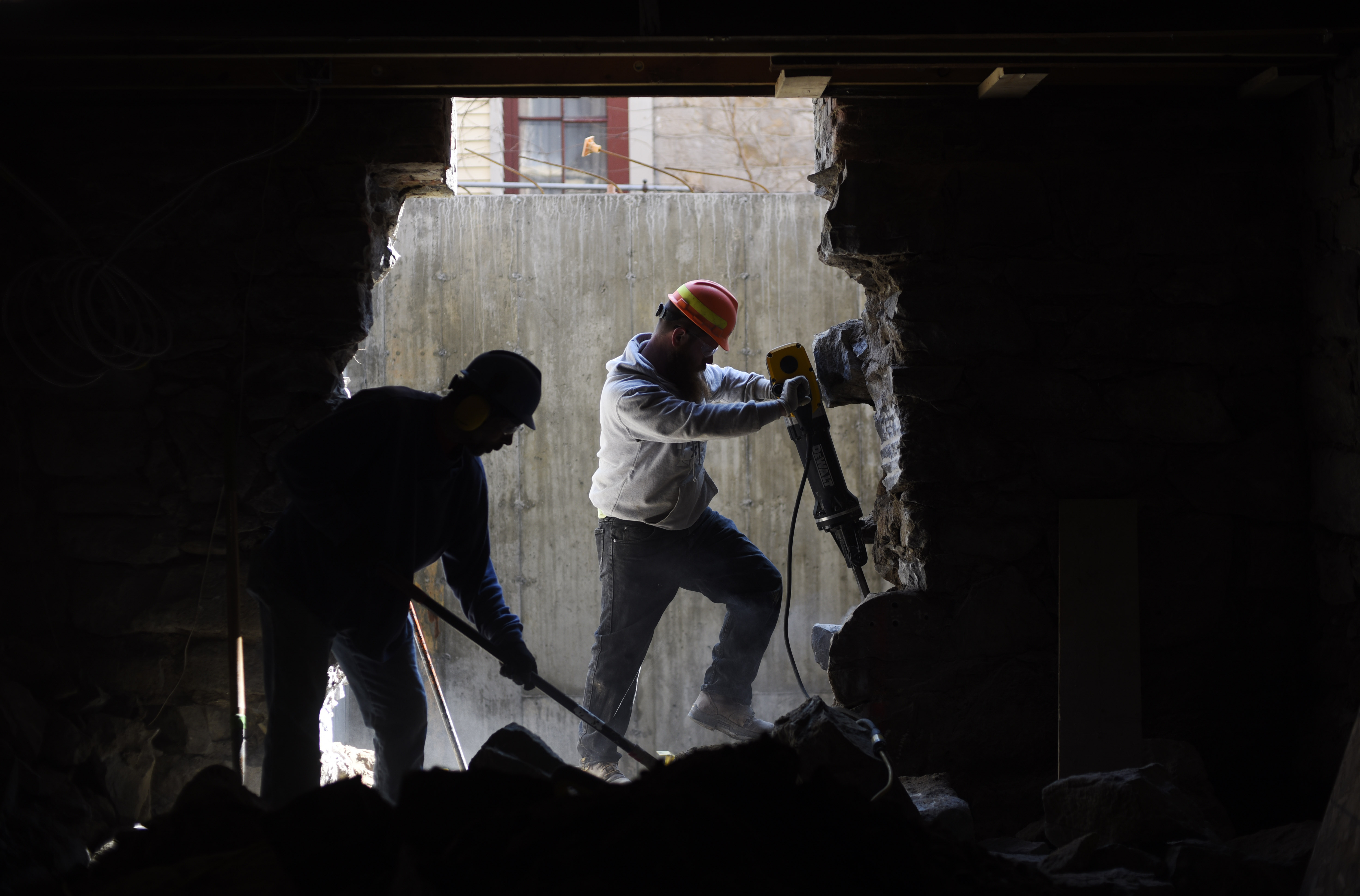 Construction workers use a jackhammer and shovel to break up and clear stone on the basement at Universal Preservation Hall in Saratoga Tuesday, April 9, 2019.