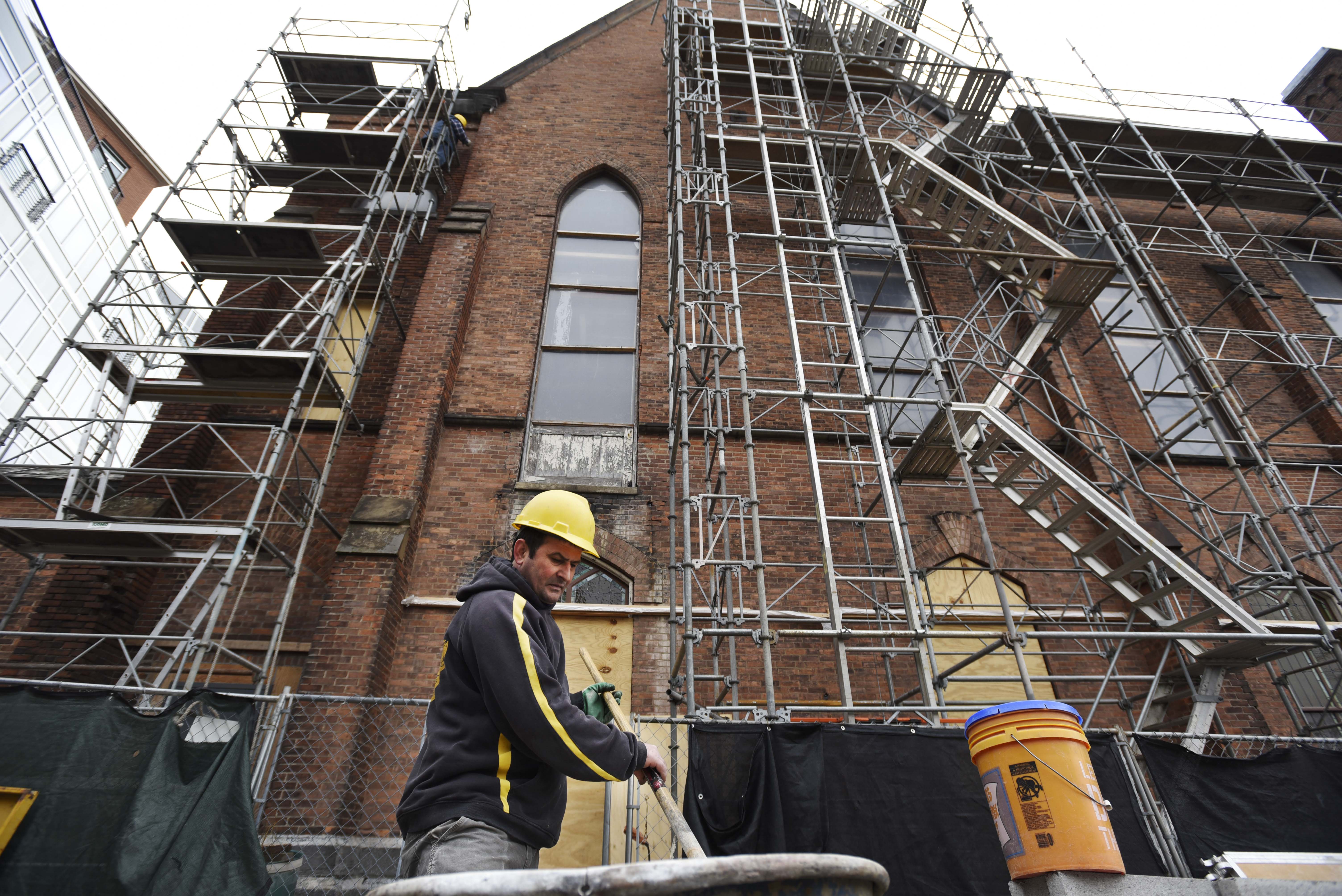 A construction workers mixes lime to use in brick restoration work on the exterior of Universal Preservation Hall in Saratoga Tuesday, April 9, 2019.