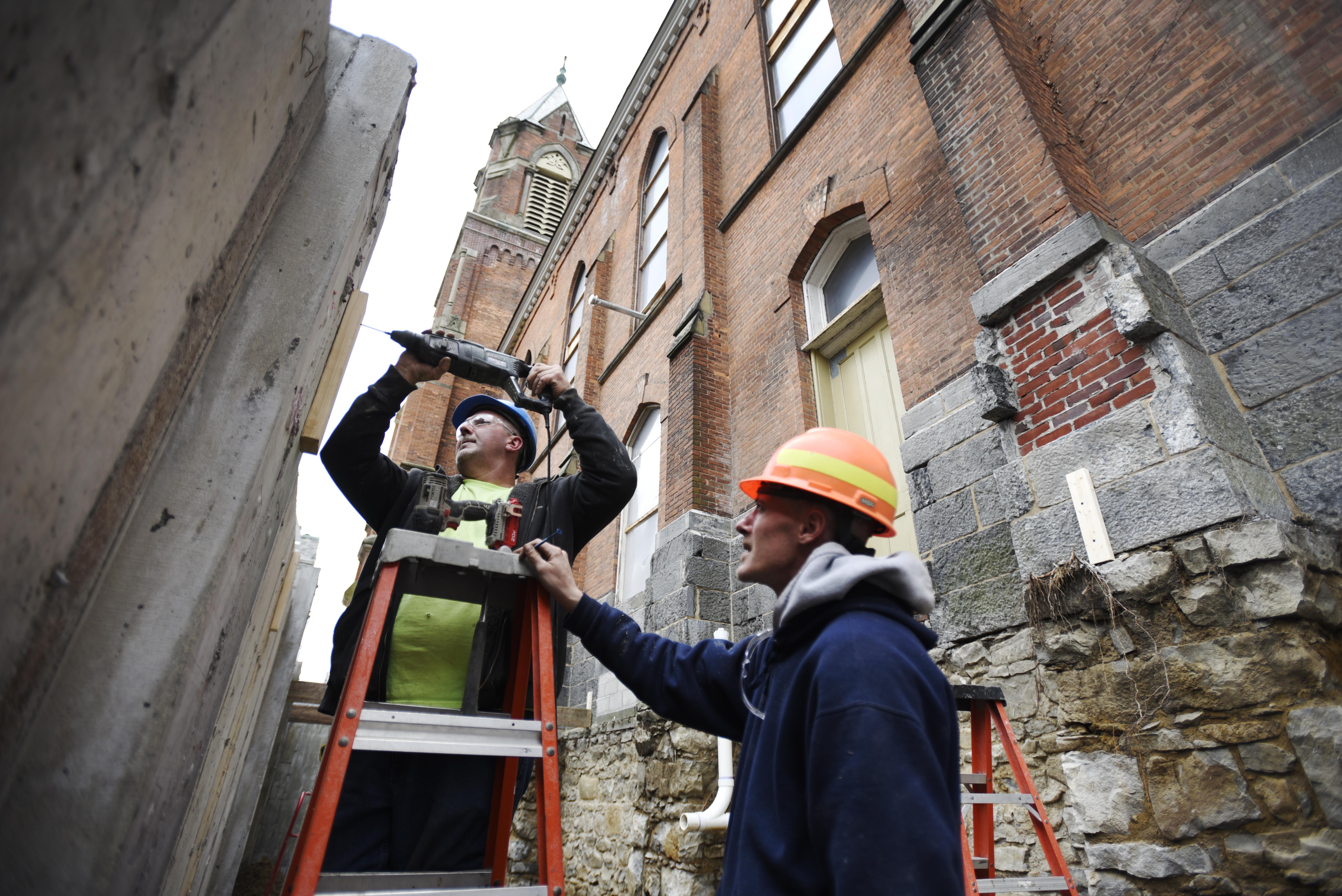 Construction workers work on the exterior at Universal Preservation Hall in Saratoga Tuesday, April 9, 2019.