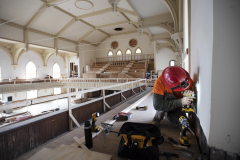 A construction worker does electrical work in the great hall at Universal Preservation Hall in Saratoga Tuesday, April 9, 2019.