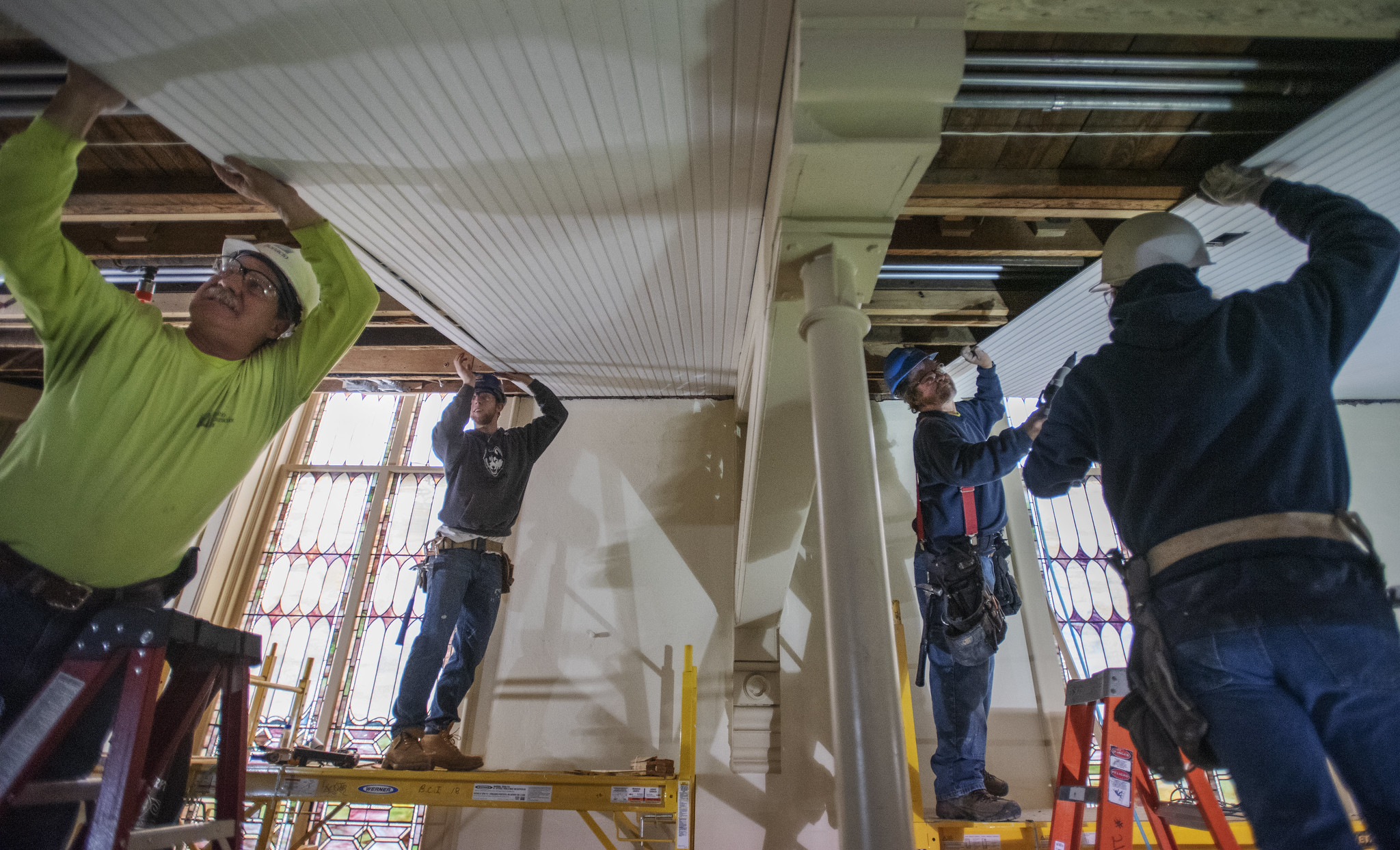 Construction workers attach wainscotting under the balcony during construction at UPH Monday, Novermber 11, 2019. A construction worker said it would take 300 miles of wainscotting to complete the project. Photo credit: Kate Penn - Proctors