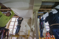 Construction workers attach wainscotting under the balcony during construction at UPH Monday, Novermber 11, 2019. A construction worker said it would take 300 miles of wainscotting to complete the project. Photo credit: Kate Penn - Proctors